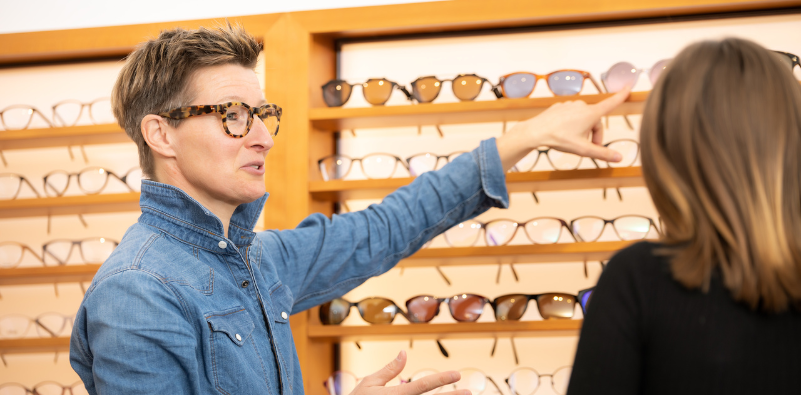 An eyewear specialist assists a customer