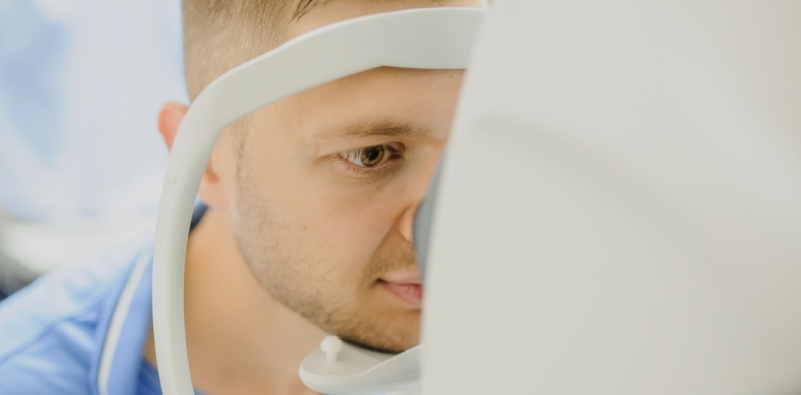 Patient undergoing eye assessment with advanced equipment